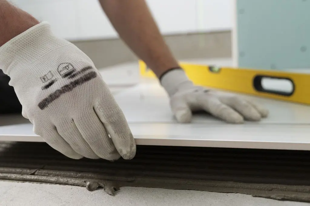 A tiler works on the floor in a Chicago area bathroom renovation.