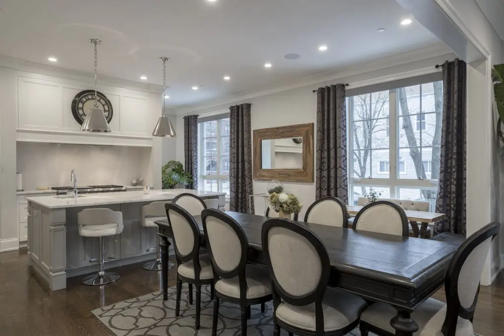 An interior shot of a luxurious house dining room with strategic home lighting design.