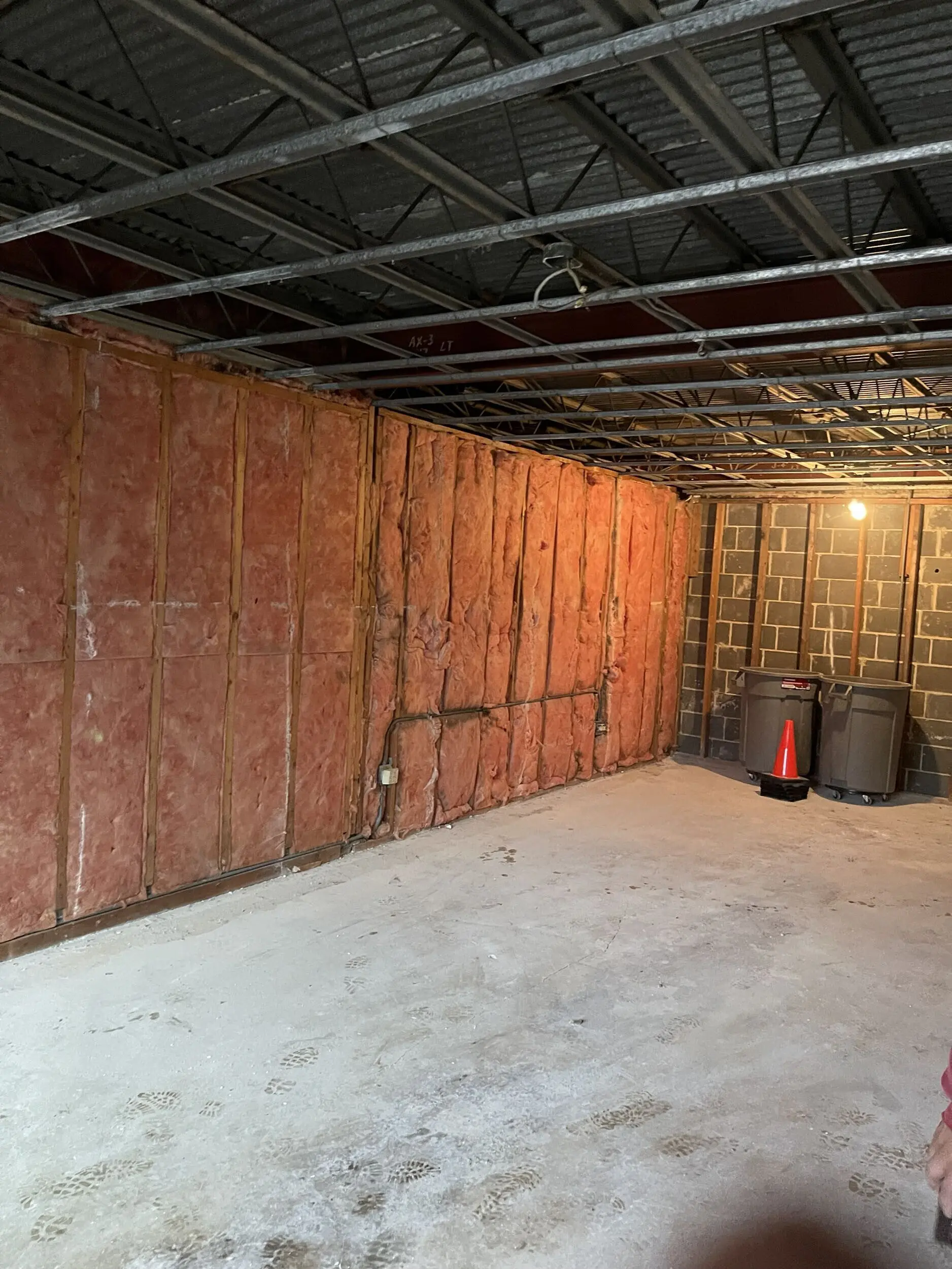 Exterior wall stripped to insulation with the ceiling opened above