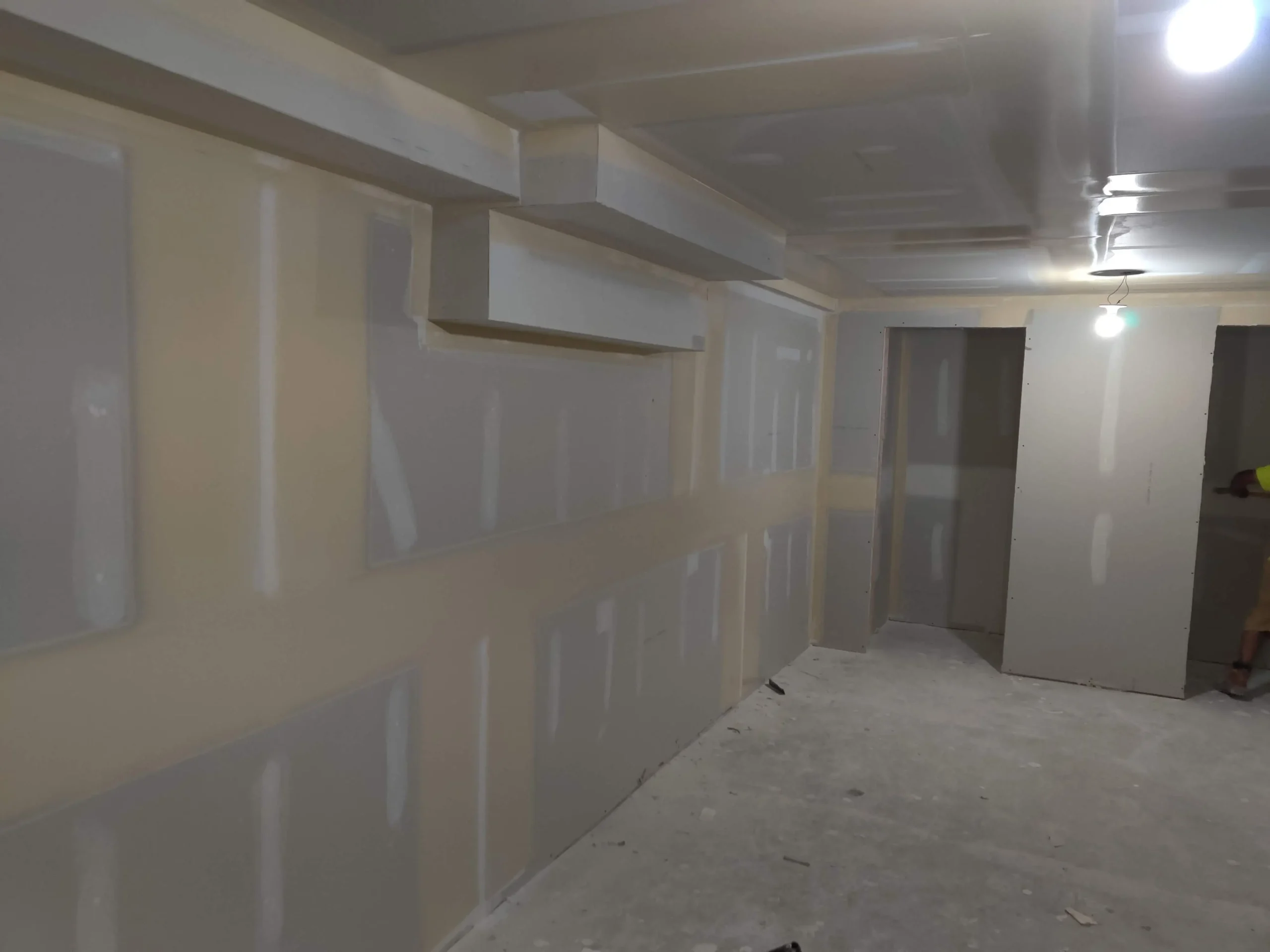 Basement hallway with new drywall hung and taped